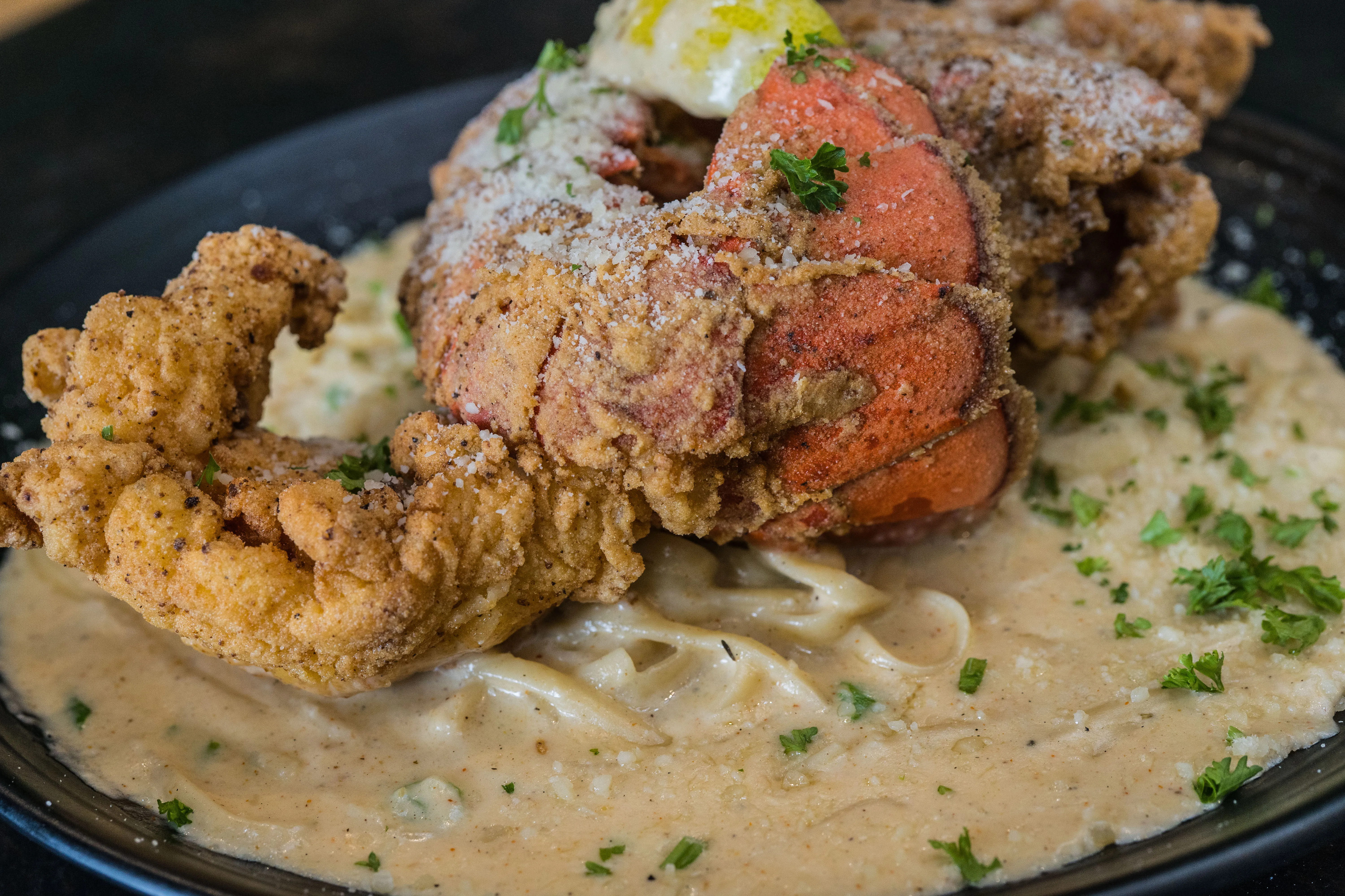 2 fried lobster tails · linguine · cajun cream sauce · charred lemon