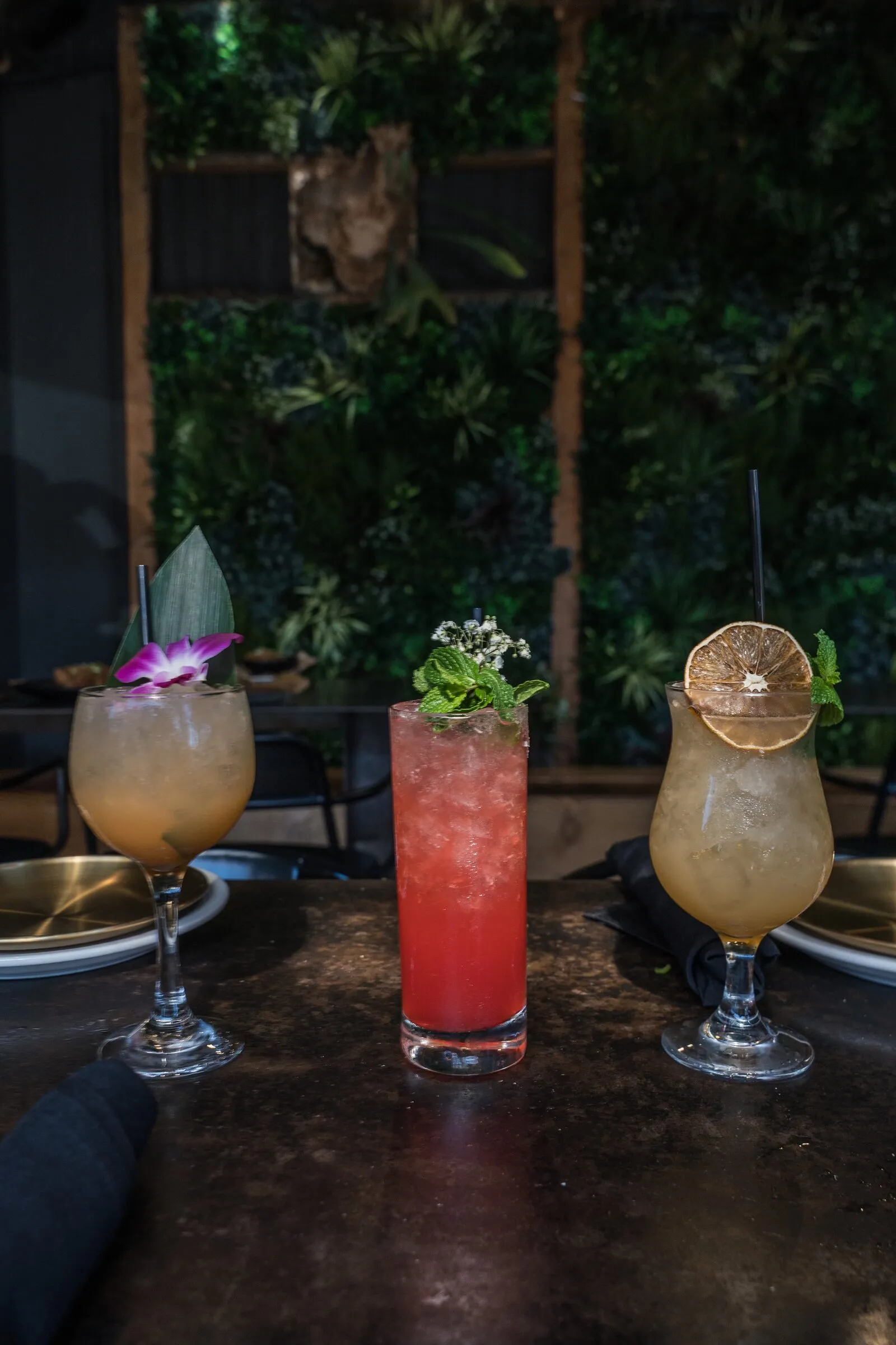 Three signature cocktails on the patio at Louisiana Purchase North Park San Diego
