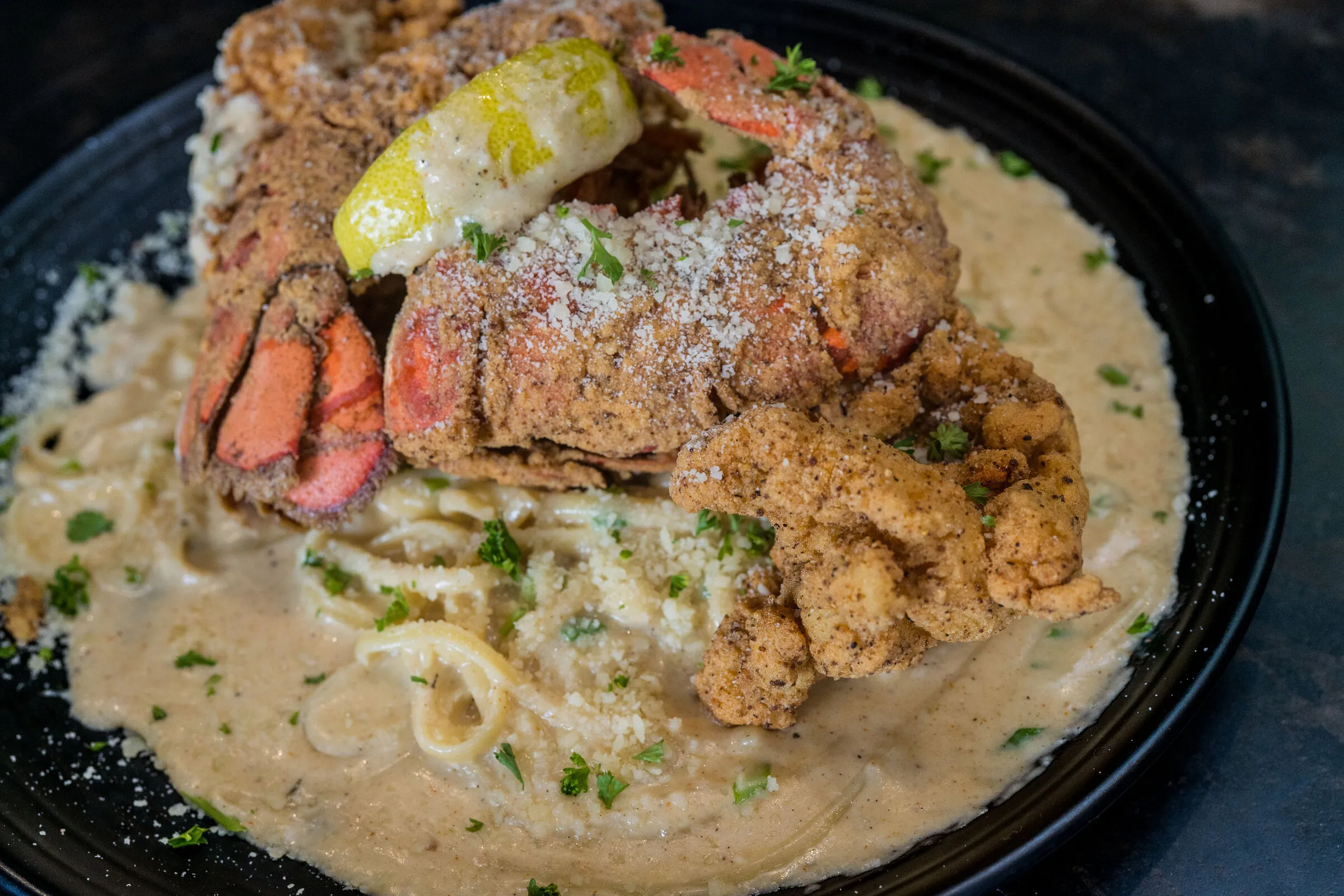 Dragos — chicken lobster topped with Cajun cream pasta at Louisiana Purchase